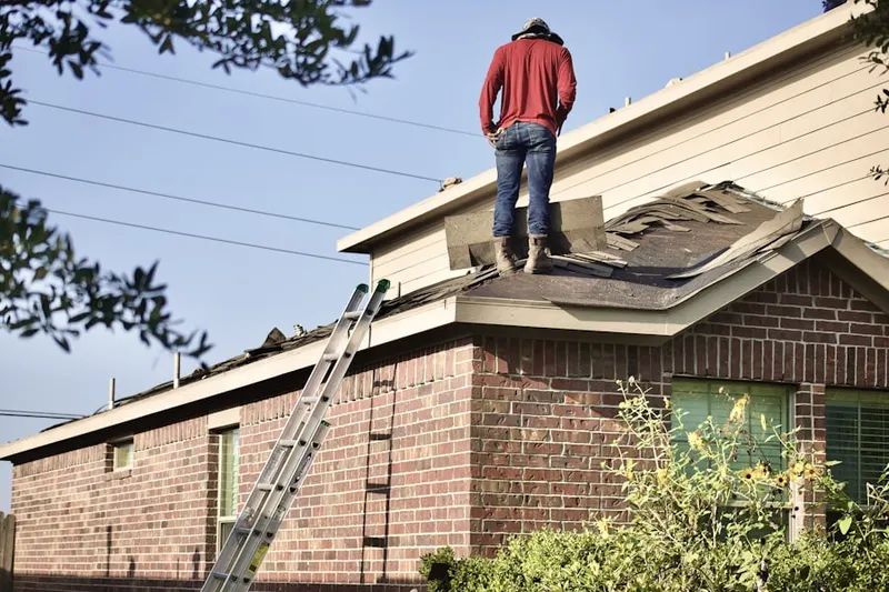 Professional roofer working on a residential roof in Snee Farms